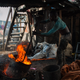 A man melting aluminum cans in Ghana’s Old Fadama slum.